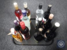 A tray of twelve bottles of spirits and wines including a 350 ml bottle of Grants whisky, Baileys,