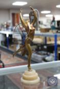 An Art Deco metal figure of a dancer on circular alabaster graduated base CONDITION