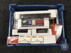 A basket of fourteen Marklin HO scales wagons and tankers, some bearing advertising, all boxed.