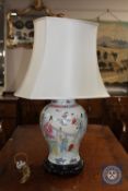 A Chinese porcelain table lamp on carved hardwood circular base CONDITION REPORT: