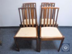 A set of four 20th century teak rail back dining chairs CONDITION REPORT: Chairs
