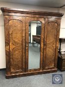 A burr walnut triple door Victorian wardrobe with fitted interior and mirror door,