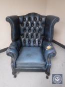 A blue button leather Chesterfield wingback armchair
