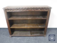 A carved oak open bookcase