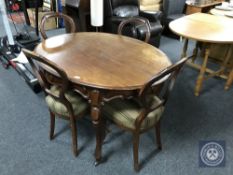 A 19th century mahogany oval dining table and four balloon back chairs
