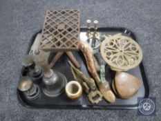 A tray of antique metal ware - trivets, copper backed hearth brush, hand bell,