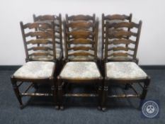 A set of six oak ladder back dining chairs