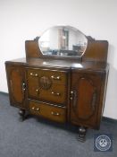 A 20th century oak break-front mirror backed sideboard