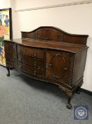An Edwardian serpentine fronted mahogany sideboard,