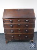 A George III and later mahogany bureau with knob handles