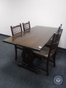 An oak refectory dining table together with a set of four oak tapestry seated dining chairs