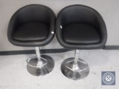 A pair of gas lift bar stools