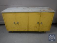 A mid 20th century four door kitchen cabinet