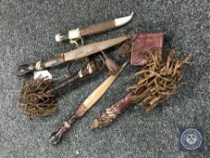 Three African daggers together with toggle pouch.