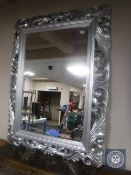 An ornate silvered overmantel mirror