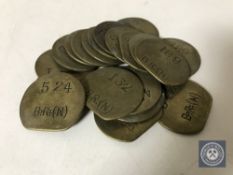 Twenty vintage brass railway pay check tokens.