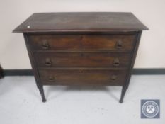 An Edwardian oak three drawer chest and a walnut bedside cabinet