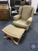 A contemporary wingback armchair and footstool