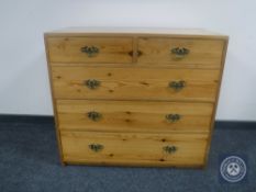 A pine five drawer chest with brass drop handles