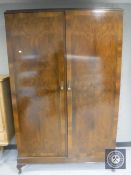An Edwardian mahogany and walnut gentleman's wardrobe