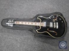 An Aria Pro II hollow body electric guitar in carry bag