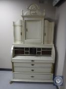 A continental cream and gilt cylinder bureau