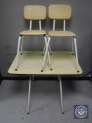 A mid 20th century melamine topped kitchen table and two chairs