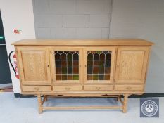 A blond oak leaded glass sideboard