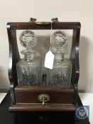 A two bottle crystal and mahogany Tantalus with key