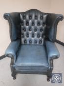 A blue button leather Chesterfield wingback armchair