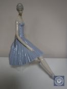 A large Lladro figure - Lady seated on rock in blue flowing dress