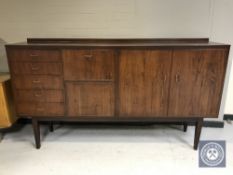 A mid 20th century teak cocktail sideboard CONDITION REPORT: 214cm wide by 48cm
