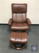 An Ekornes Stressless brown leather reclining swivel chair with footstool