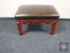 A leather upholstered dressing table stool