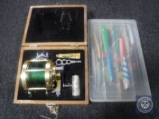 A cased Roddy 440 dominator reel together with a case of fishing lures CONDITION REPORT: