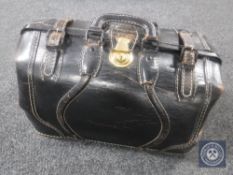 A black leather Gladstone bag