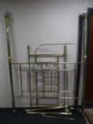A brass four-poster bed frame