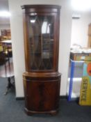 A mahogany corner display cabinet
