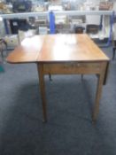A Victorian mahogany flap sided table fitted a drawer