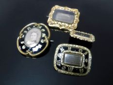 Four Victorian mourning brooches.