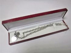 A sterling silver necklace with heart shaped pendant.