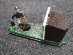A cast metal football money box