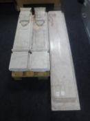 A four-piece cream marble fire surround