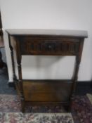 A shaped Jaycee Oak hall table fitted a drawer