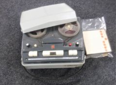 A vintage reel to reel player with reels