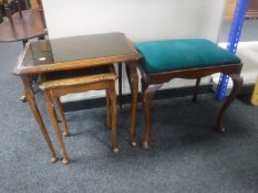 A mahogany dressing table and nest of three glass and leather topped tables