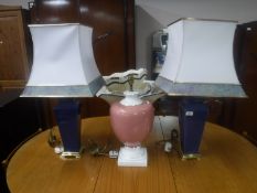 A pair of blue pottery table lamps on gilt metal bases,