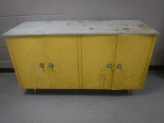 A mid 20th century four door kitchen cabinet