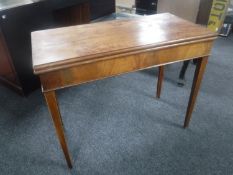 A 19th century mahogany foldover tea table