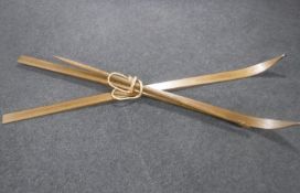 A pair of wooden Nordic skis together with a pine walking pole with carved pommel
